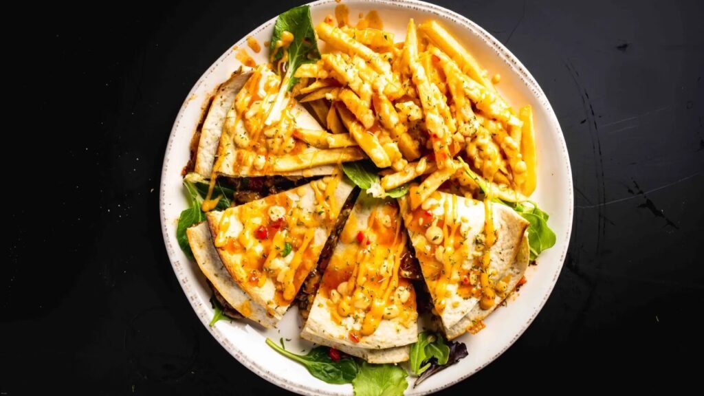 Quesadilla wedges with cheese sauce and fries