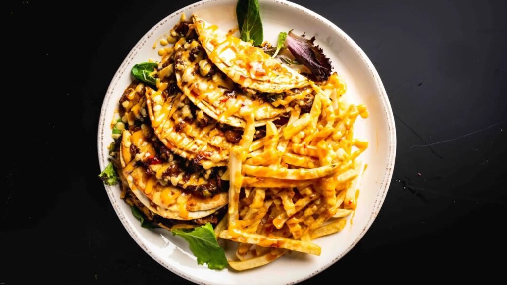 Soft tacos drizzled with cheese sauce, served with fries
